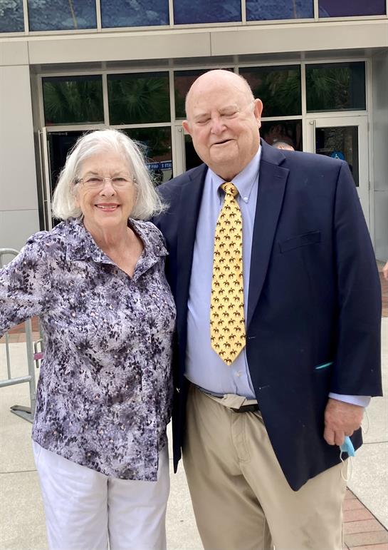 A man and woman standing together outside a building