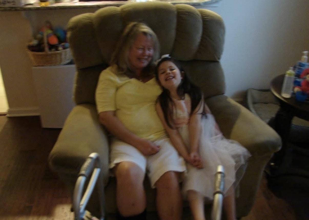 A woman and a girl sitting in a chair