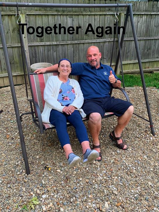 A man and woman sitting on a swing