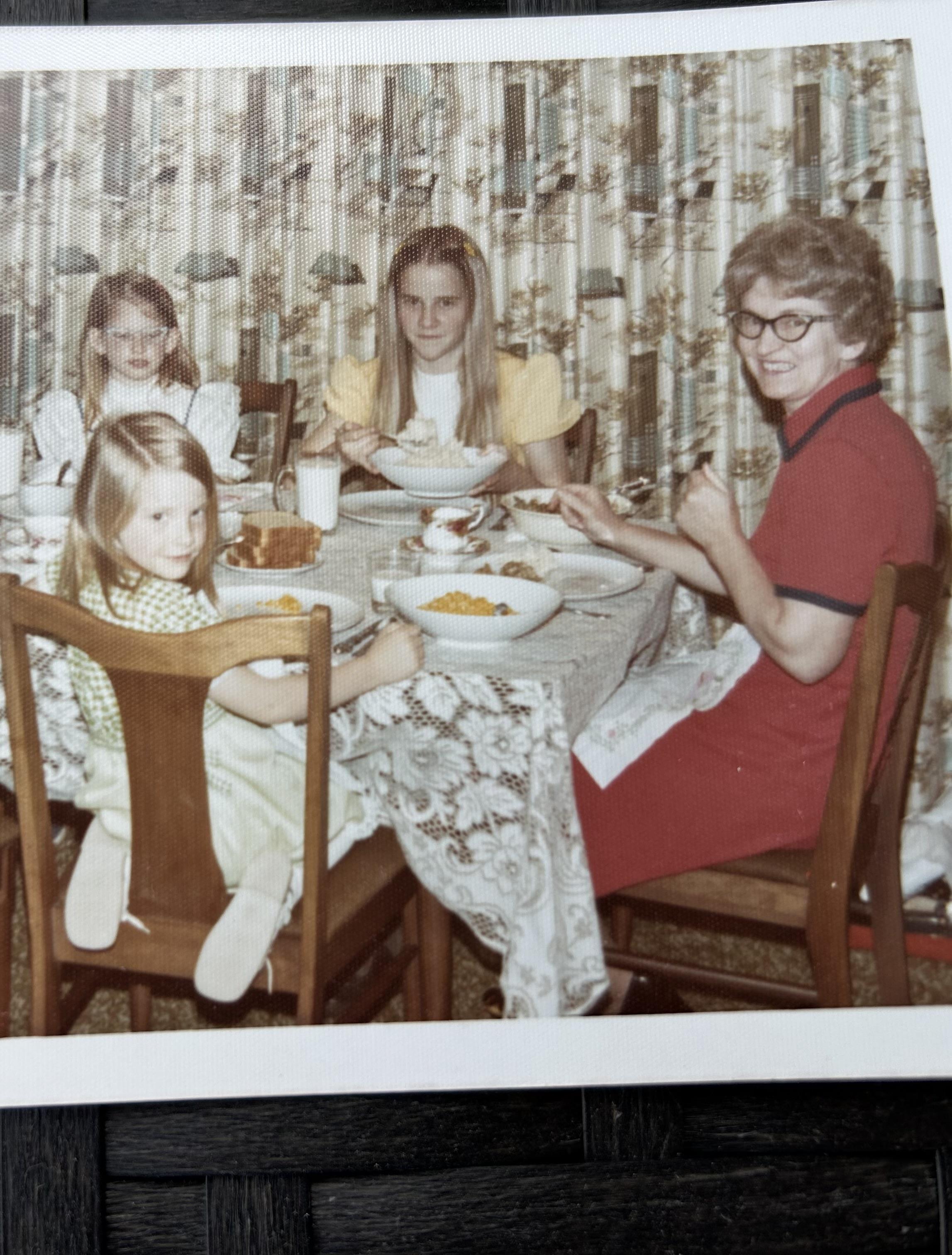 A warm gathering of family members enjoying a meal and sharing smiles around a table.