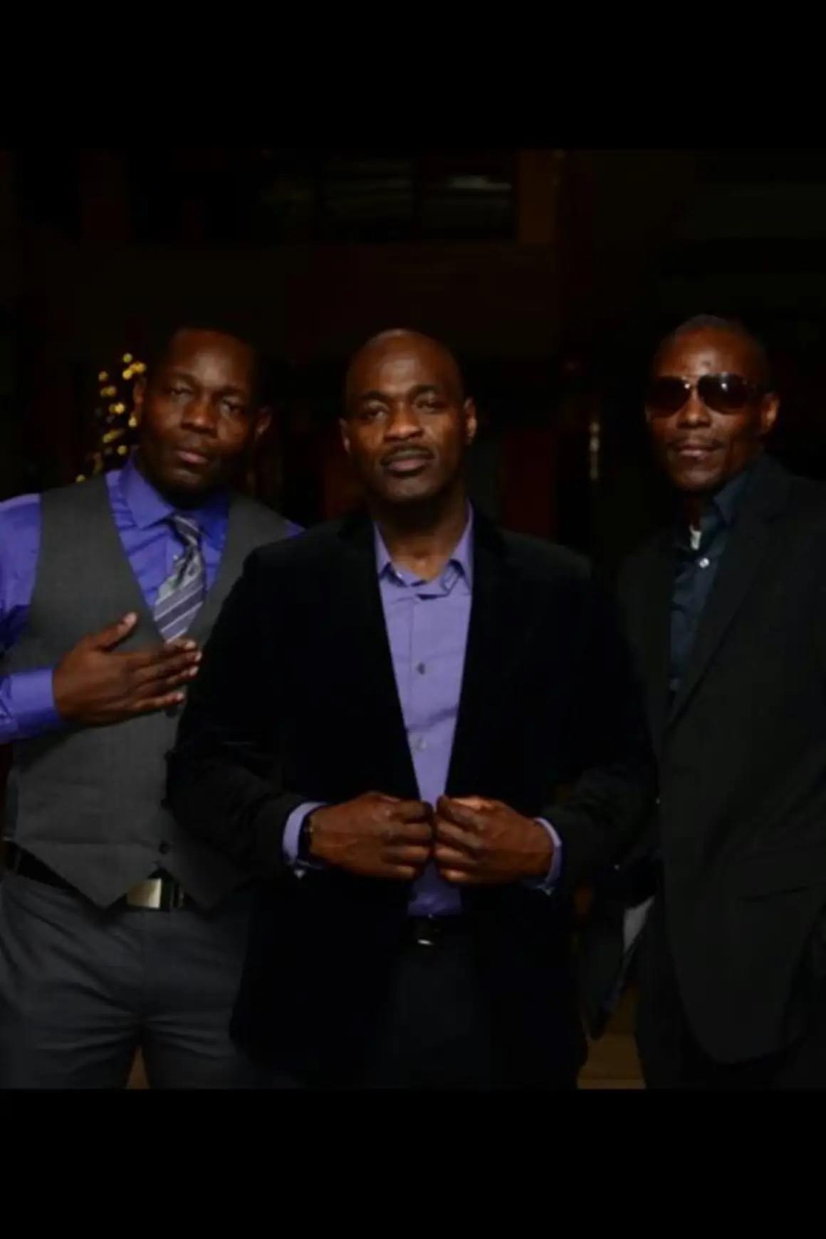 Three gentlemen in formal wear showcase camaraderie at an upscale gathering.