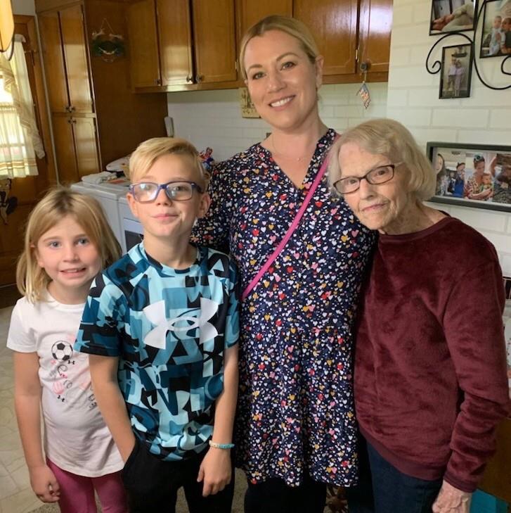 Children and their grandmother enjoy a warm family moment in a comfortable home setting.