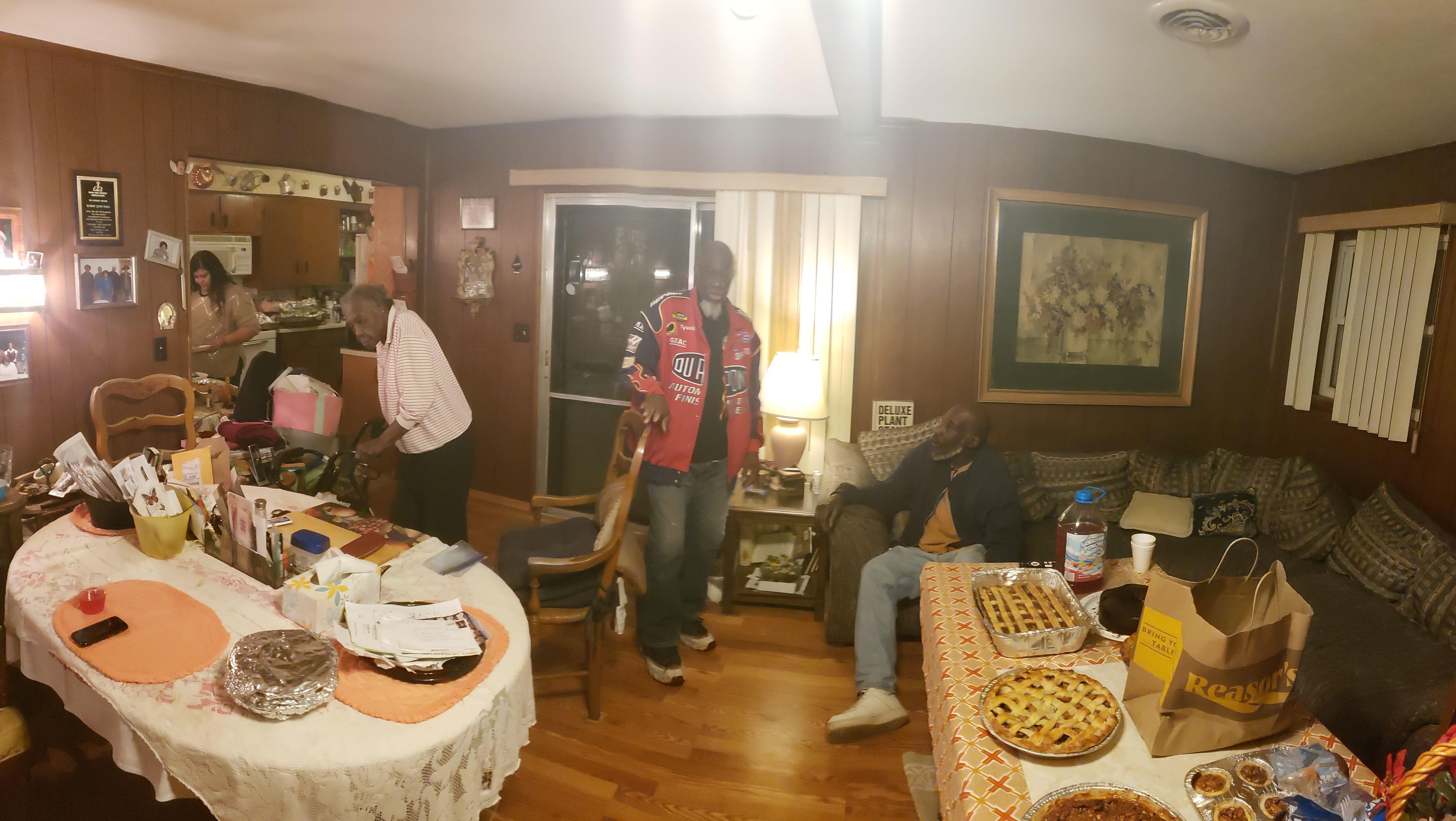 A lively gathering unfolds in a comfortable living room where friends enjoy delicious food.