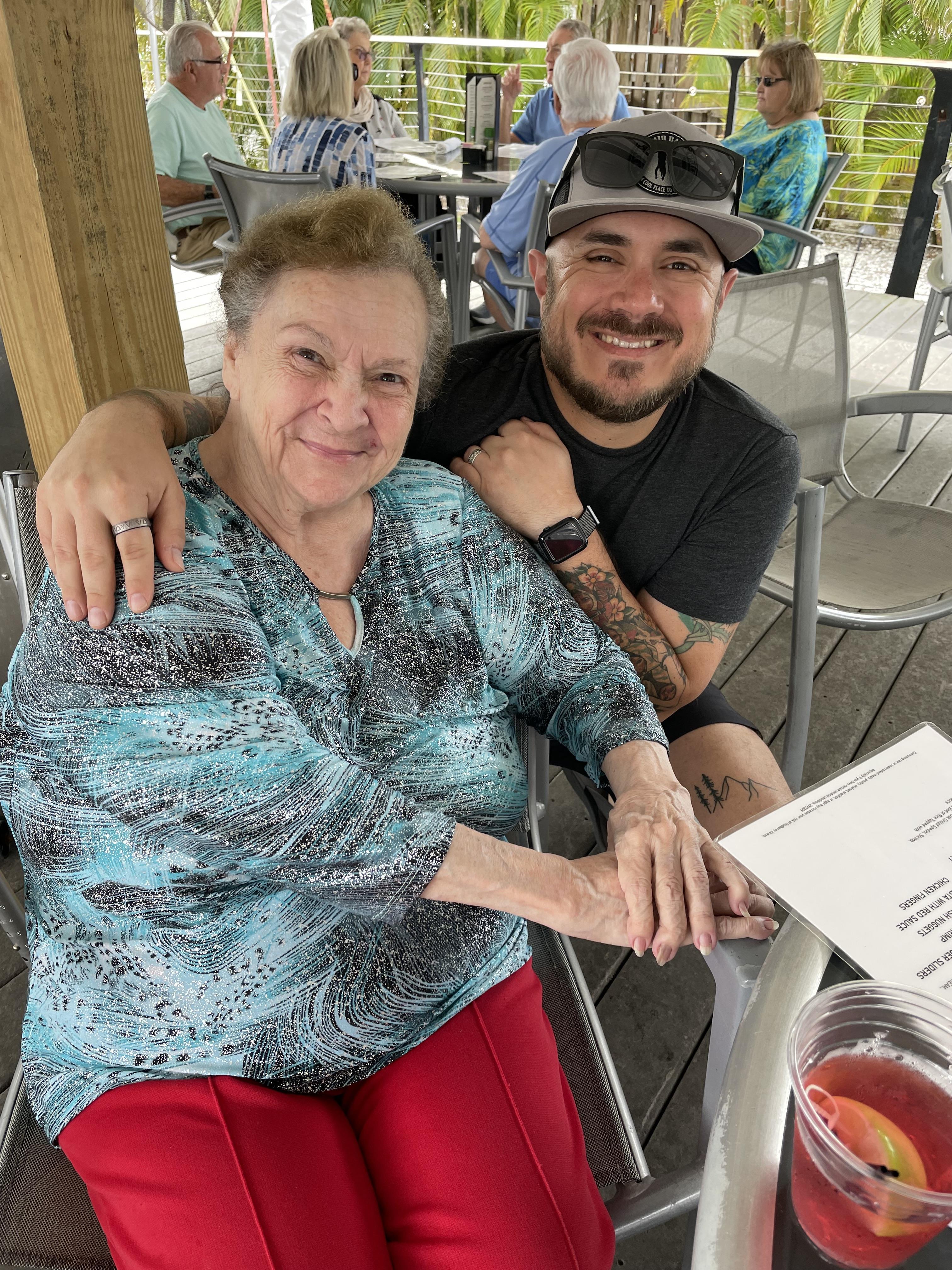 People enjoy a cheerful afternoon together at a cafe, sharing warm smiles and conversation.