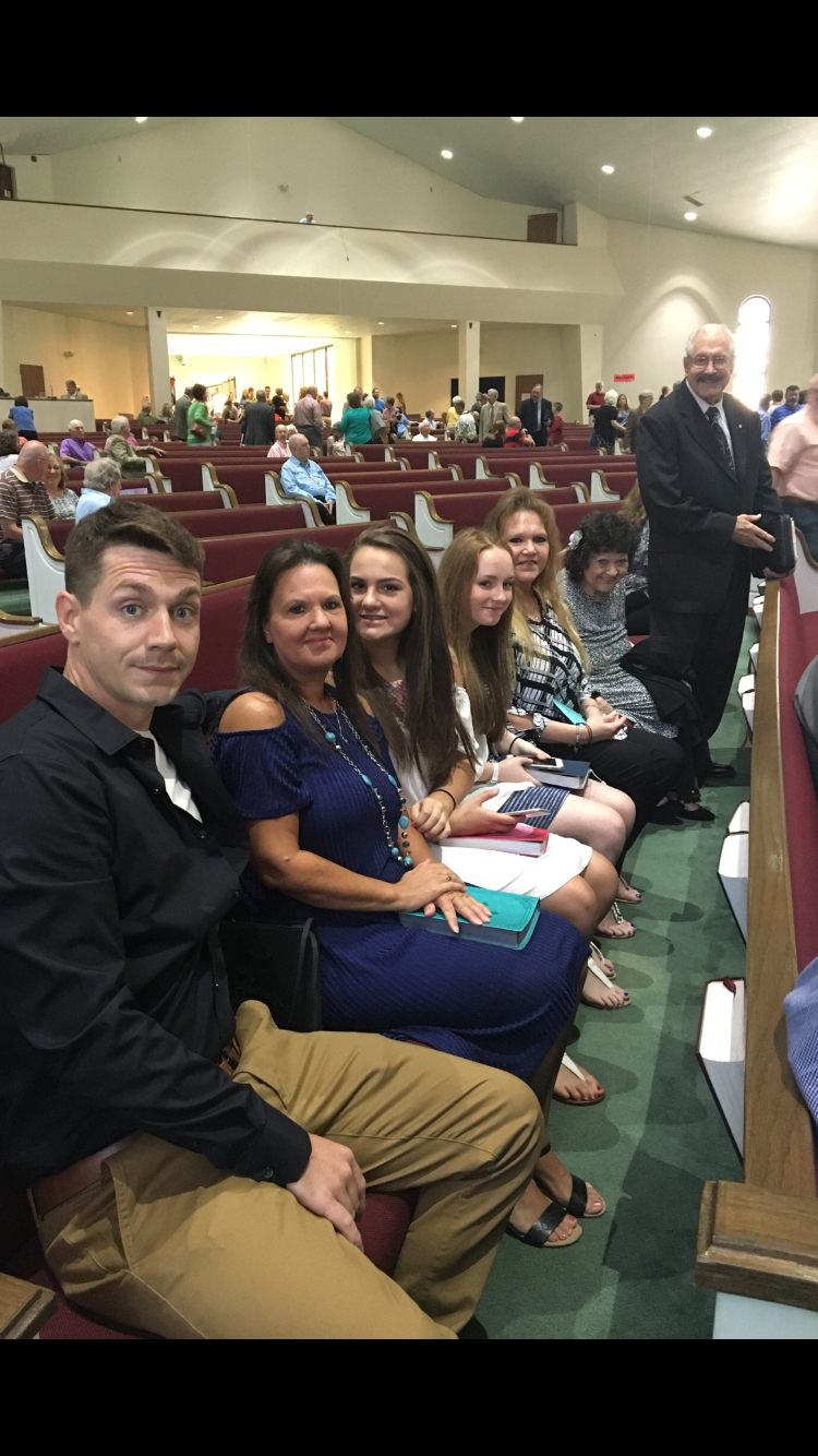 People relax and converse while waiting for a significant community event to begin.