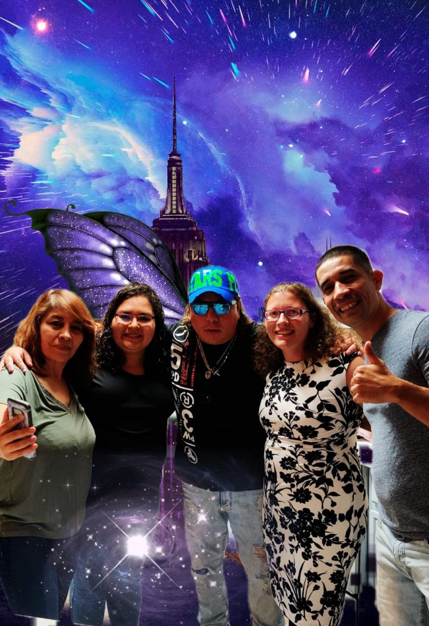 Friends smiling in casual wear, celebrating with creativity all around them.