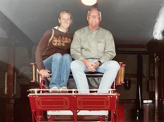 A man and woman sitting on a carriage
