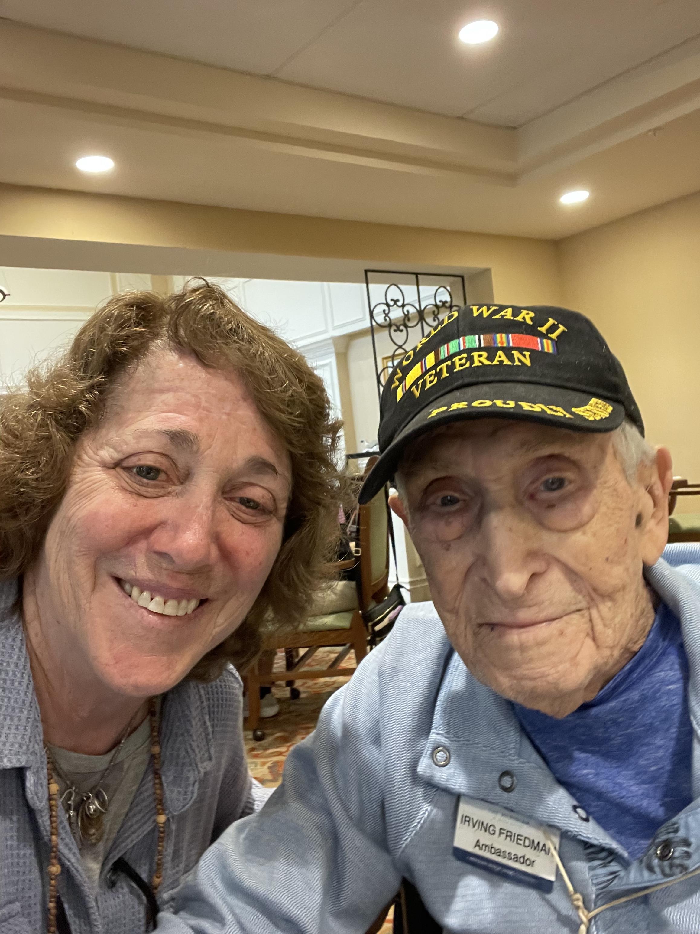 Two individuals smiling together, showcasing camaraderie and connection at a lively event.