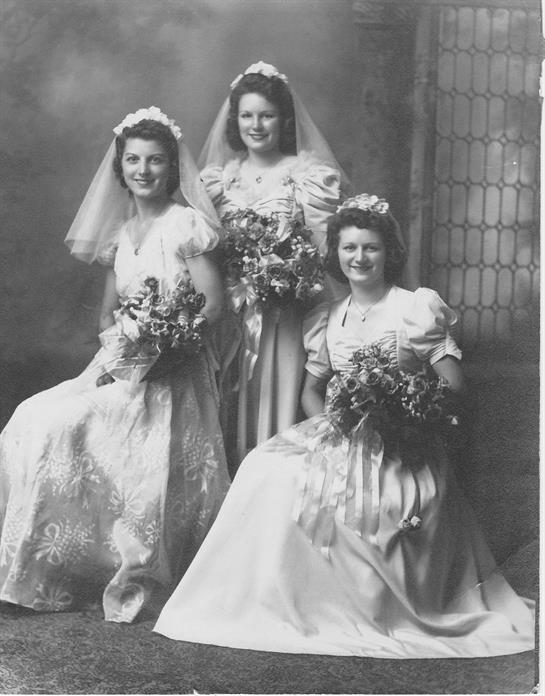 A group of women in wedding dresses