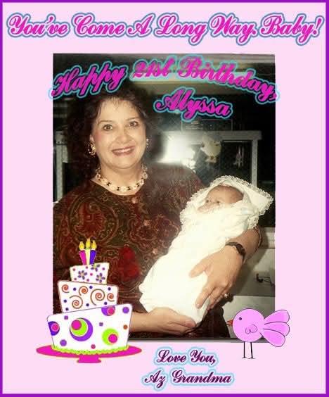 A woman holds a newborn baby during a joyful birthday celebration, surrounded by decorations.