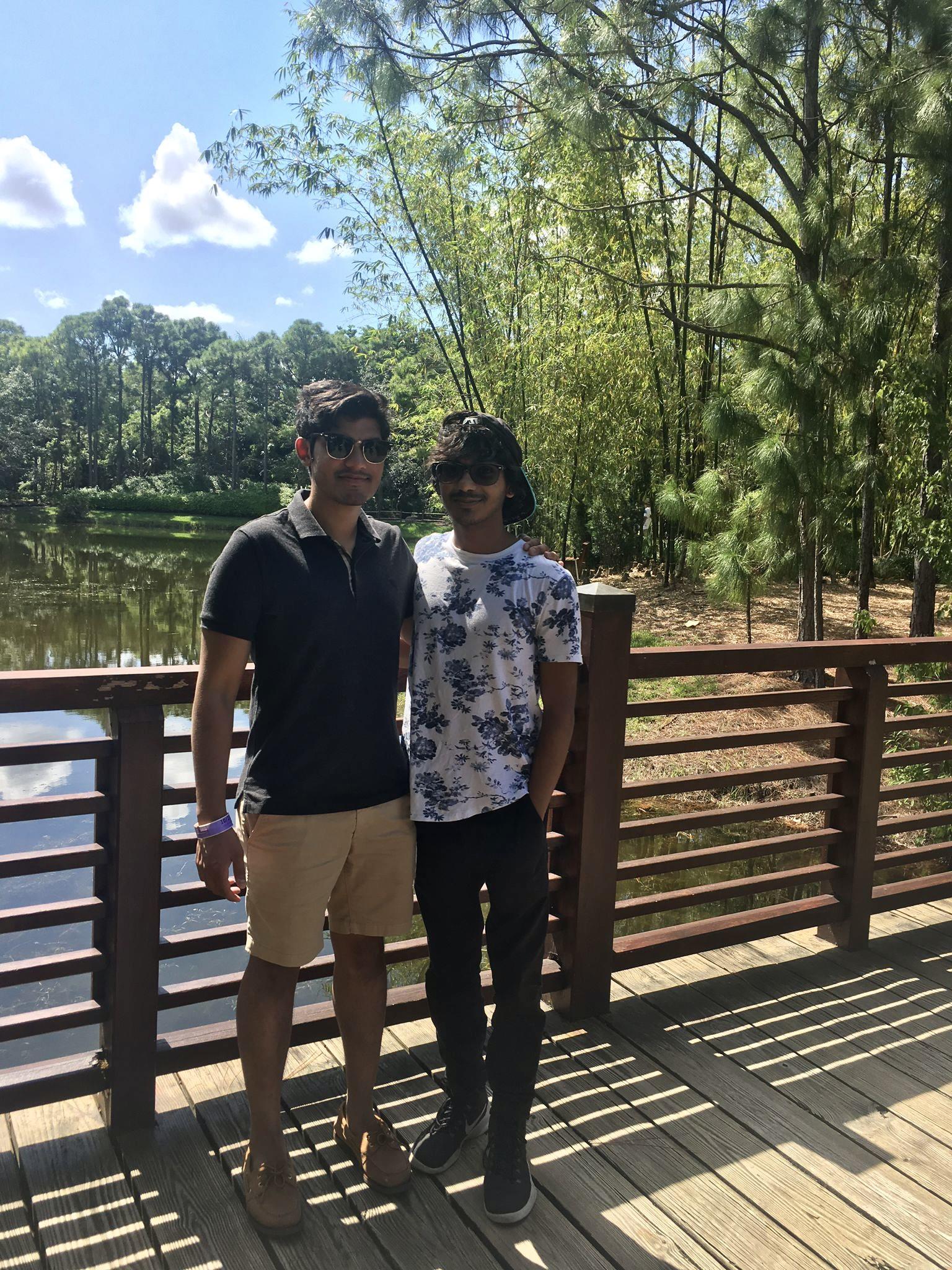 Two men standing on a bridge