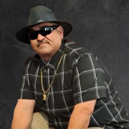 A man wearing a hat and sunglasses