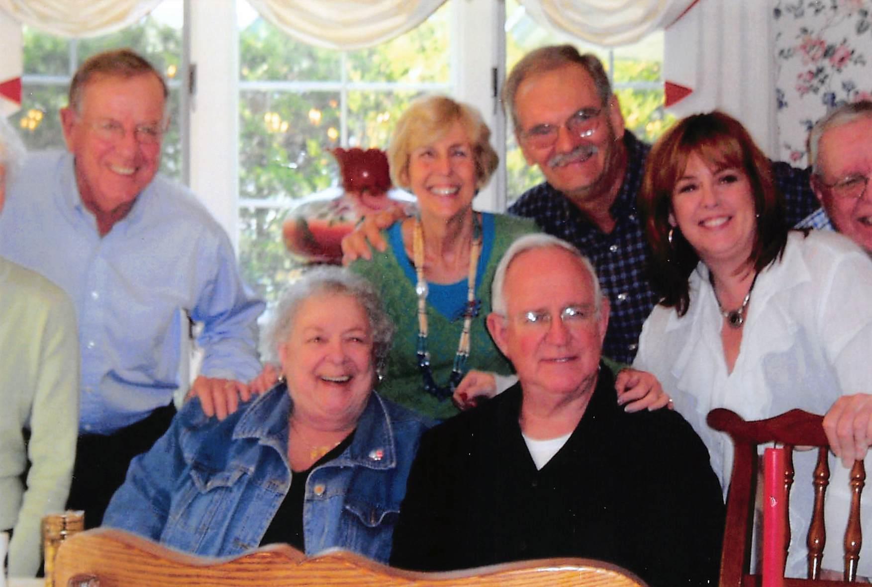 Relatives smiling and enjoying each other's company in a bright, welcoming space.