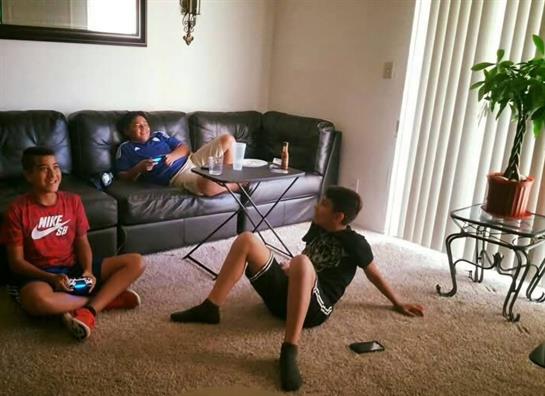 A group of people sitting on the floor in a living room