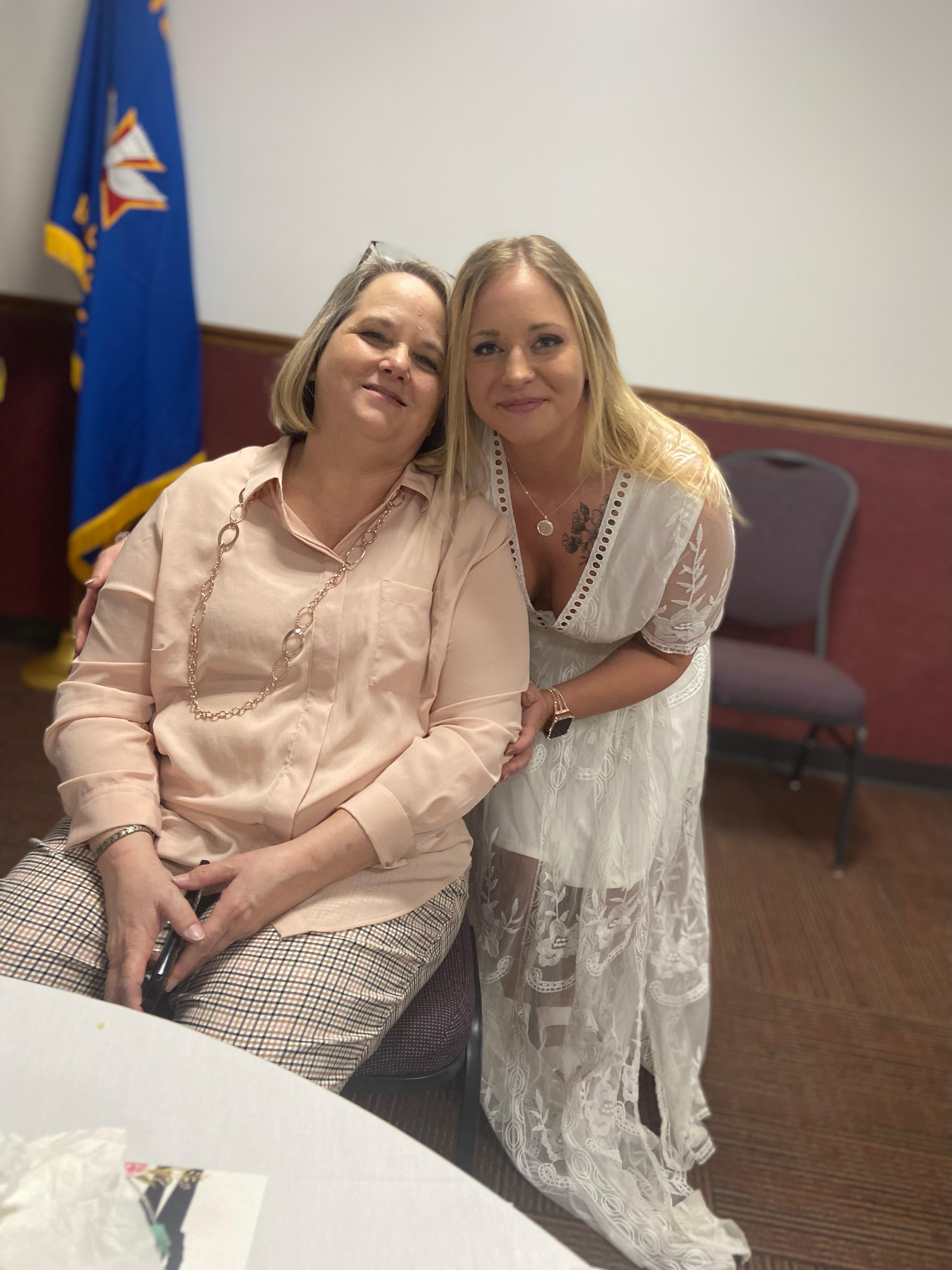 Two women sitting together smiling
