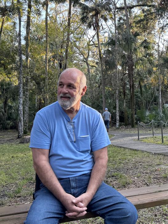 A man sitting on a bench outside