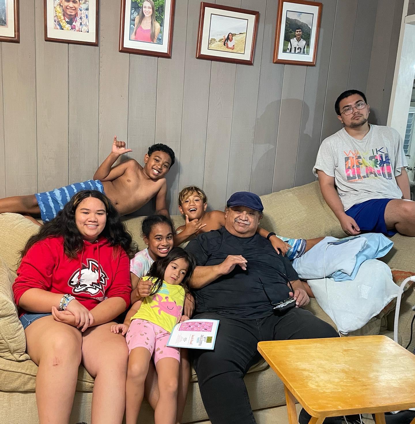 A joyful family gathering in a living room, with kids playing and adults relaxing happily.