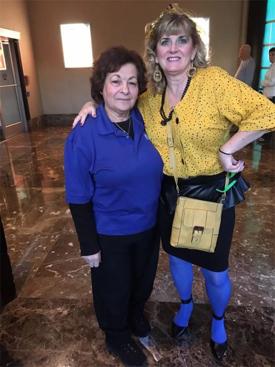 Two women standing together in a room