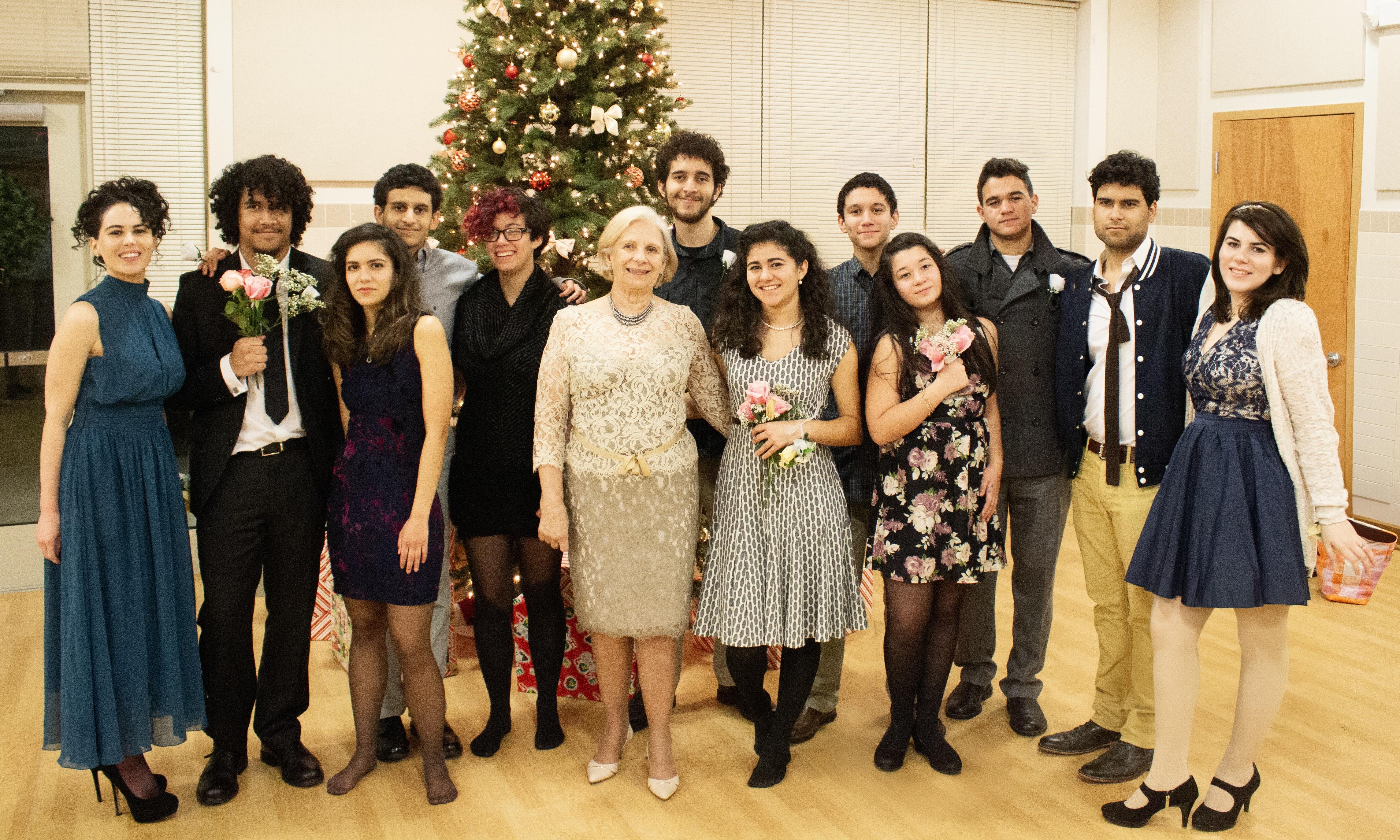 A lively gathering of friends wearing evening attire celebrating during a holiday event.