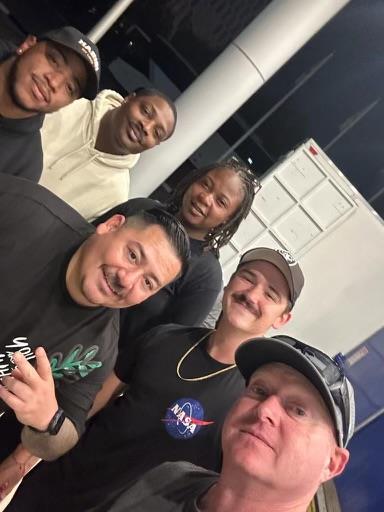 Friends pose together, smiling and having fun in a lively gathering atmosphere.