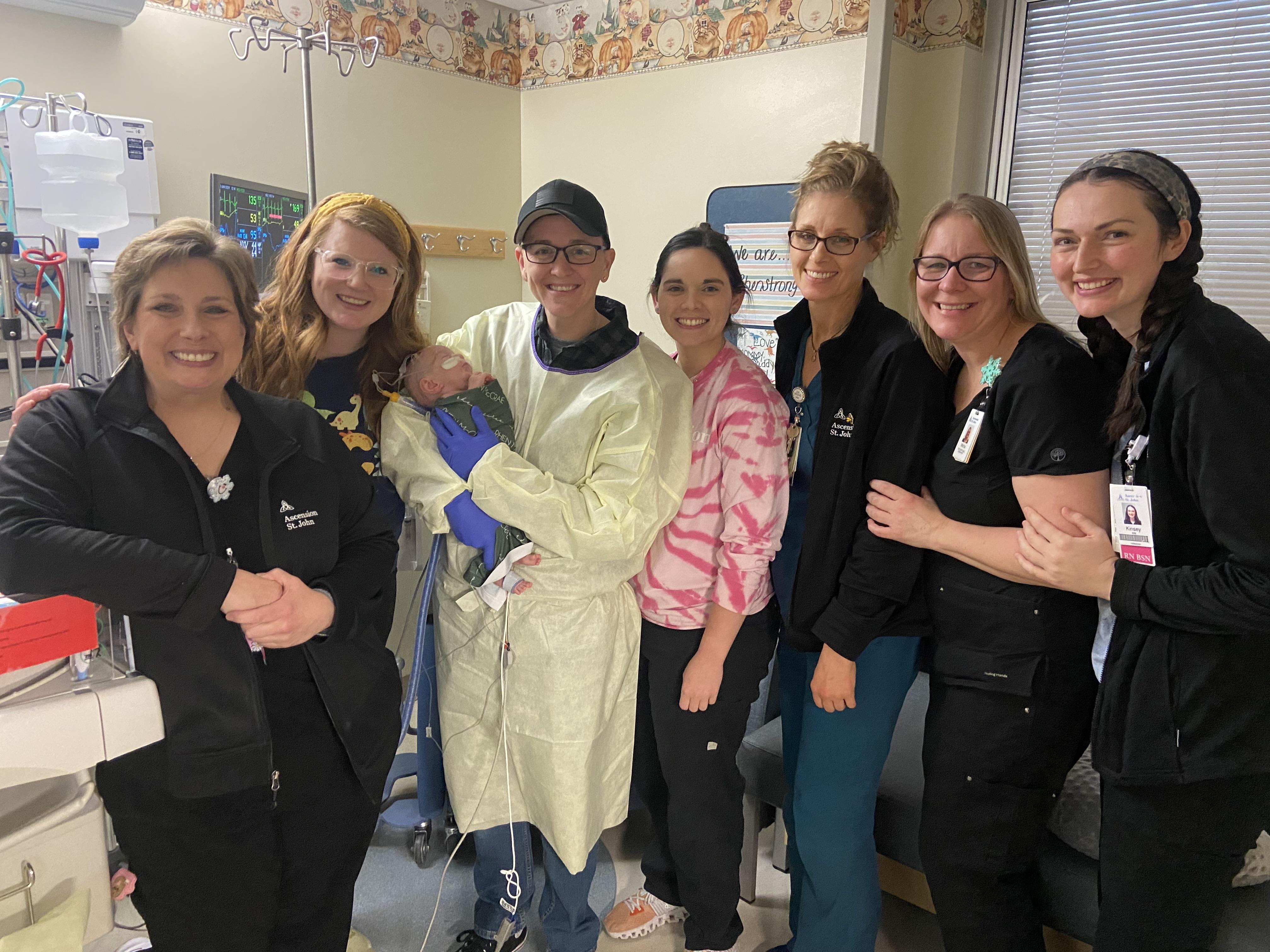 A group of dedicated health care professionals smiles together after a rewarding day at work.