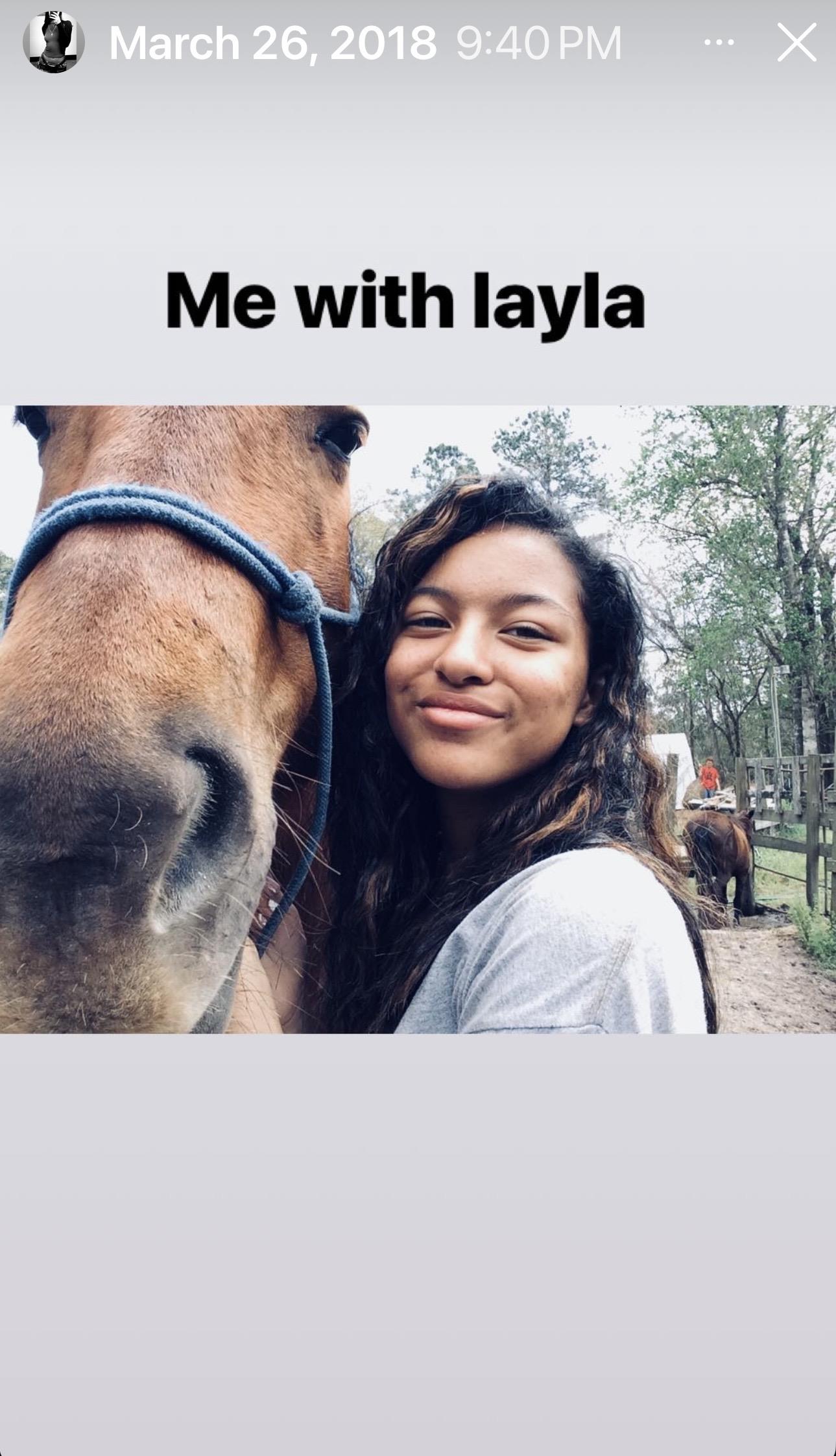 A woman taking a selfie with a horse