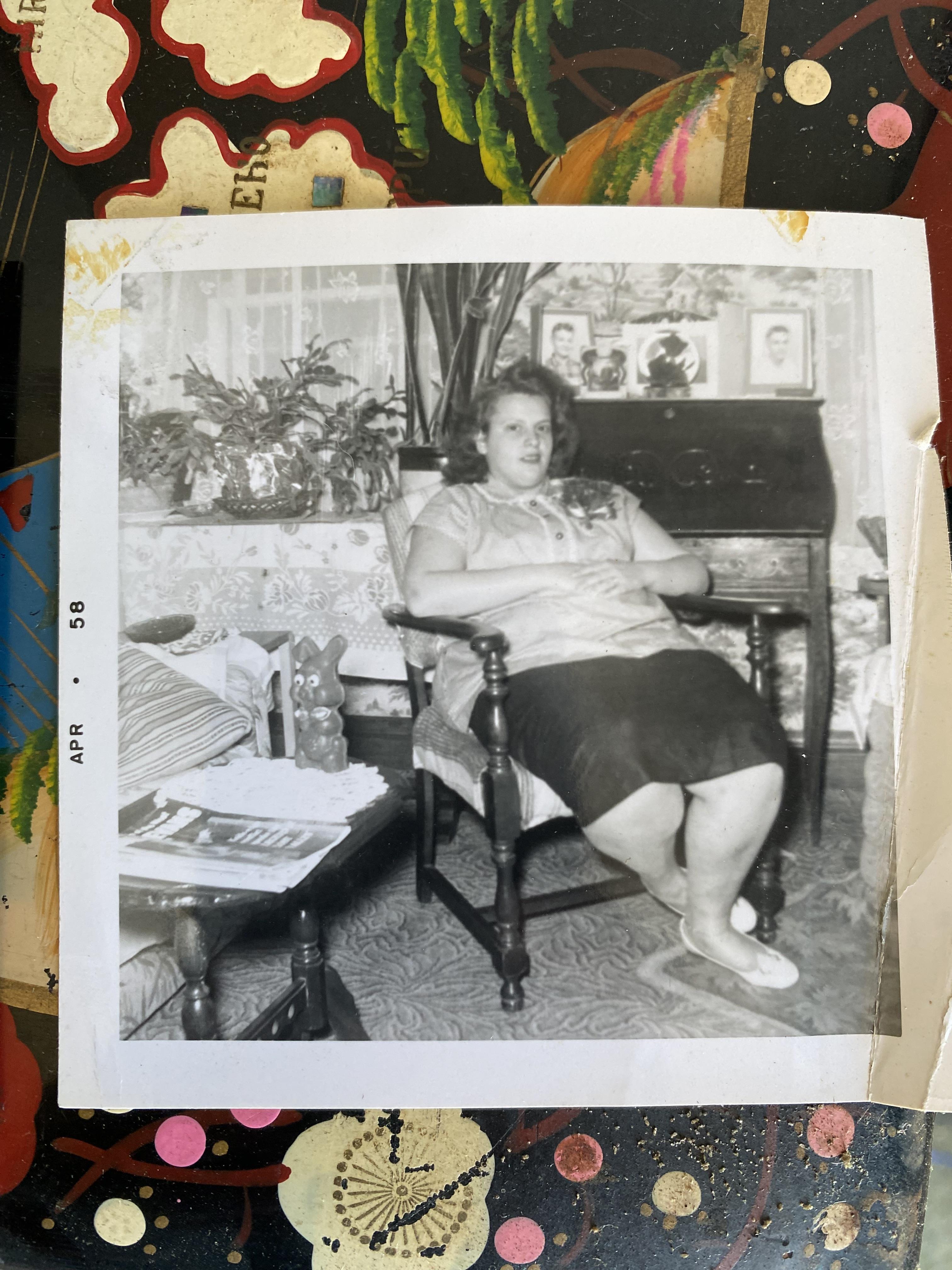 A woman sits comfortably in a chair, enjoying her leisure time in a bright, inviting living room.