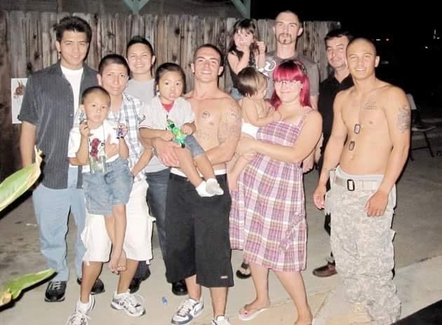 A group of friends enjoys a lively gathering outdoors at night, celebrating with laughter and joy.