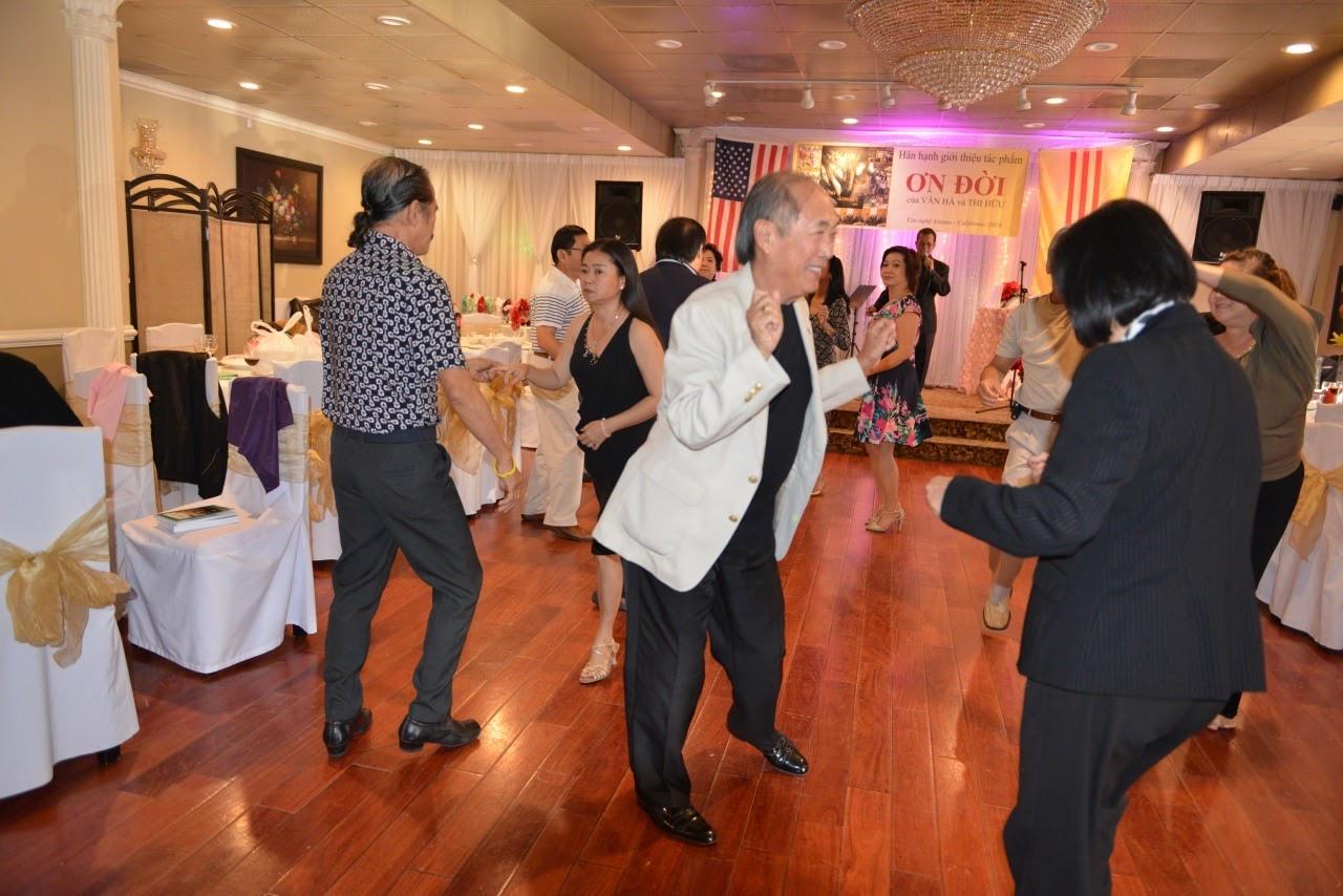 Attendees are dancing and having fun at a lively celebration.