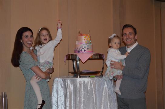 A man and woman holding two children