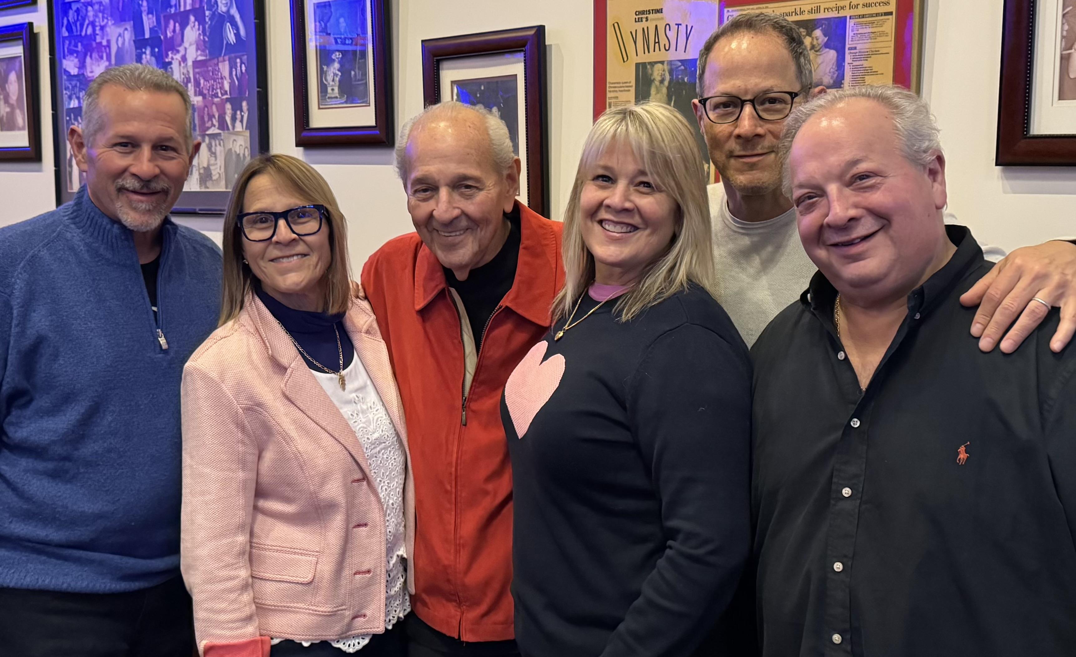 Friends enjoying each other's company in a relaxed setting filled with nostalgic memorabilia.