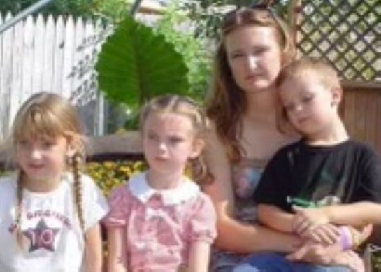 A woman and children posing for a picture