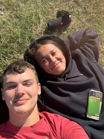 A man and woman lying on grass