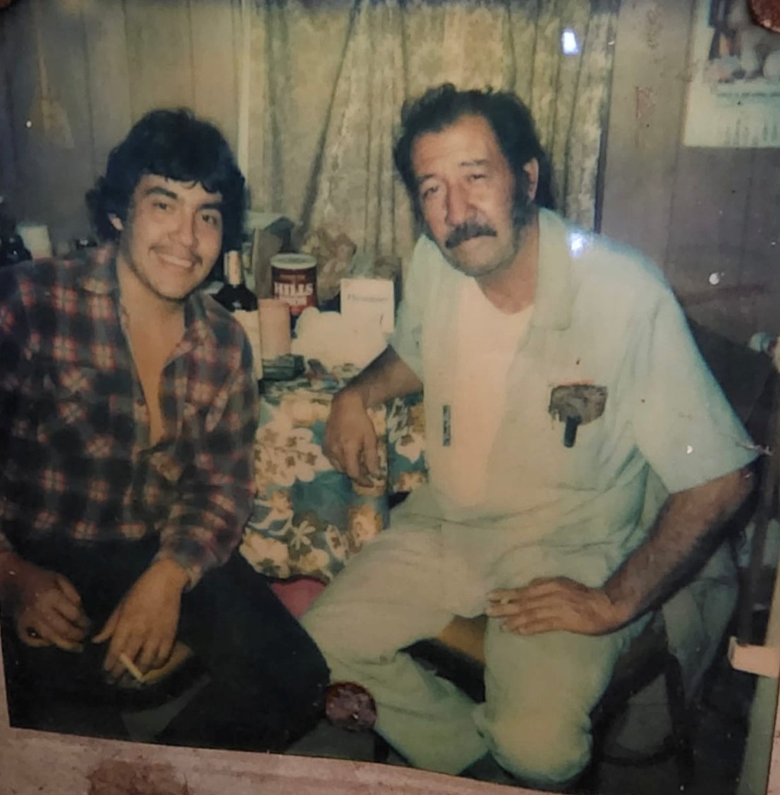 Two men sitting together smiling