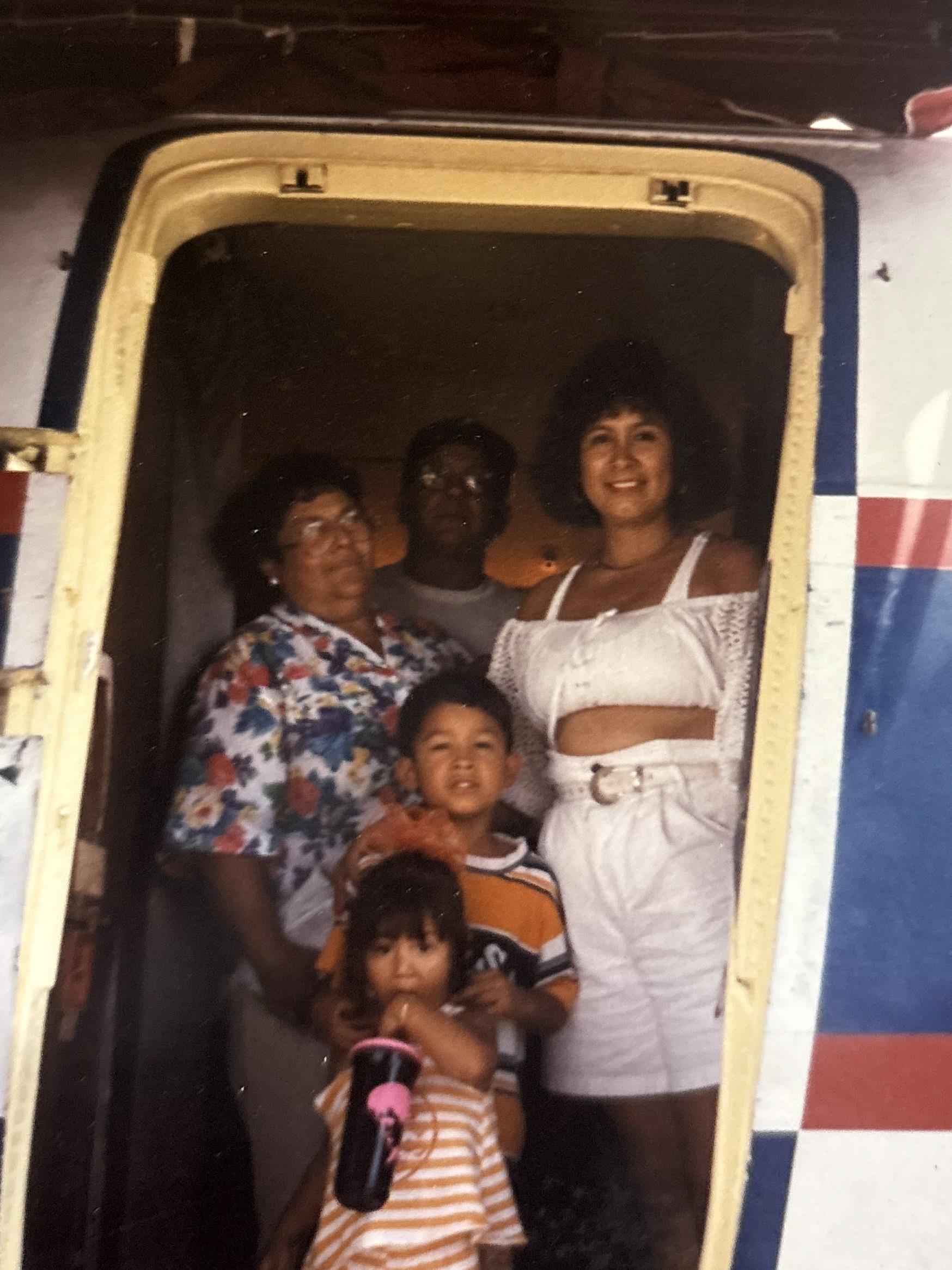 A group of family members stands inside a vintage van, showcasing their joyful connection.