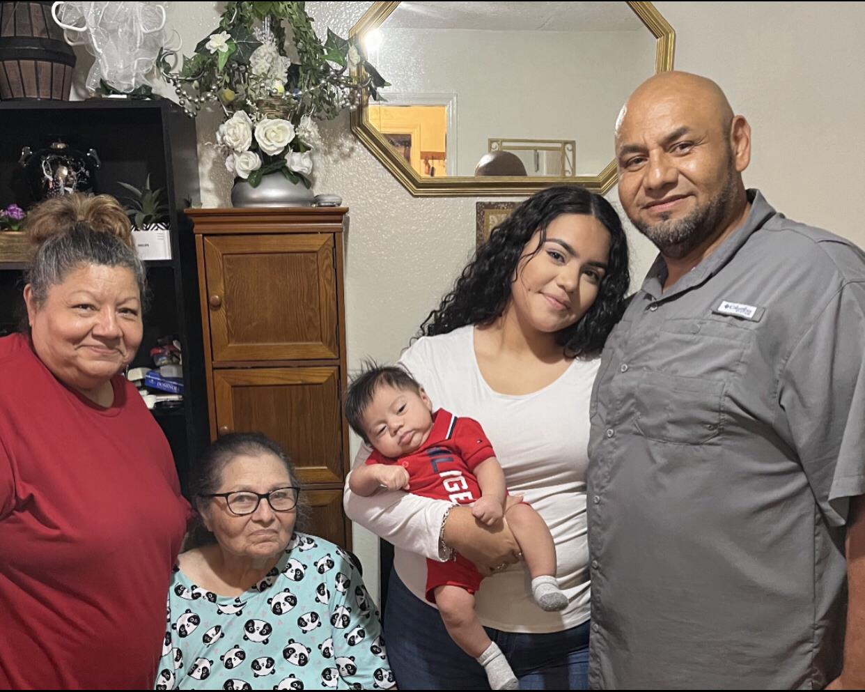 A family enjoys quality time together in a warm living room filled with love and joy.