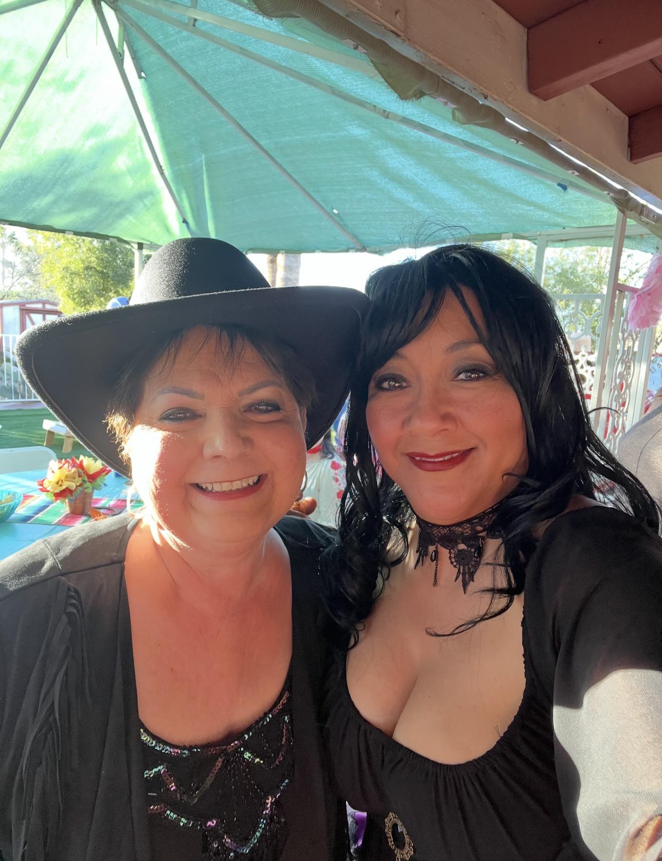 Friends in costume smile and pose together during a lively celebration by the poolside.