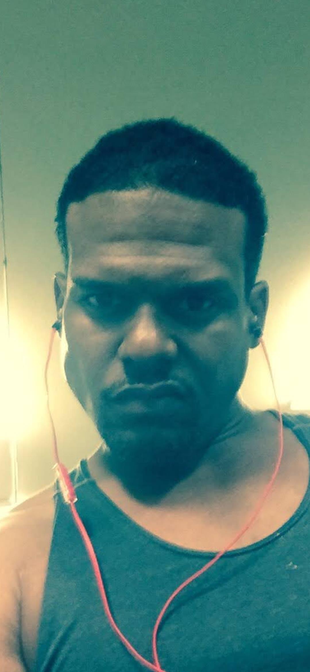 A man with earbuds on his head