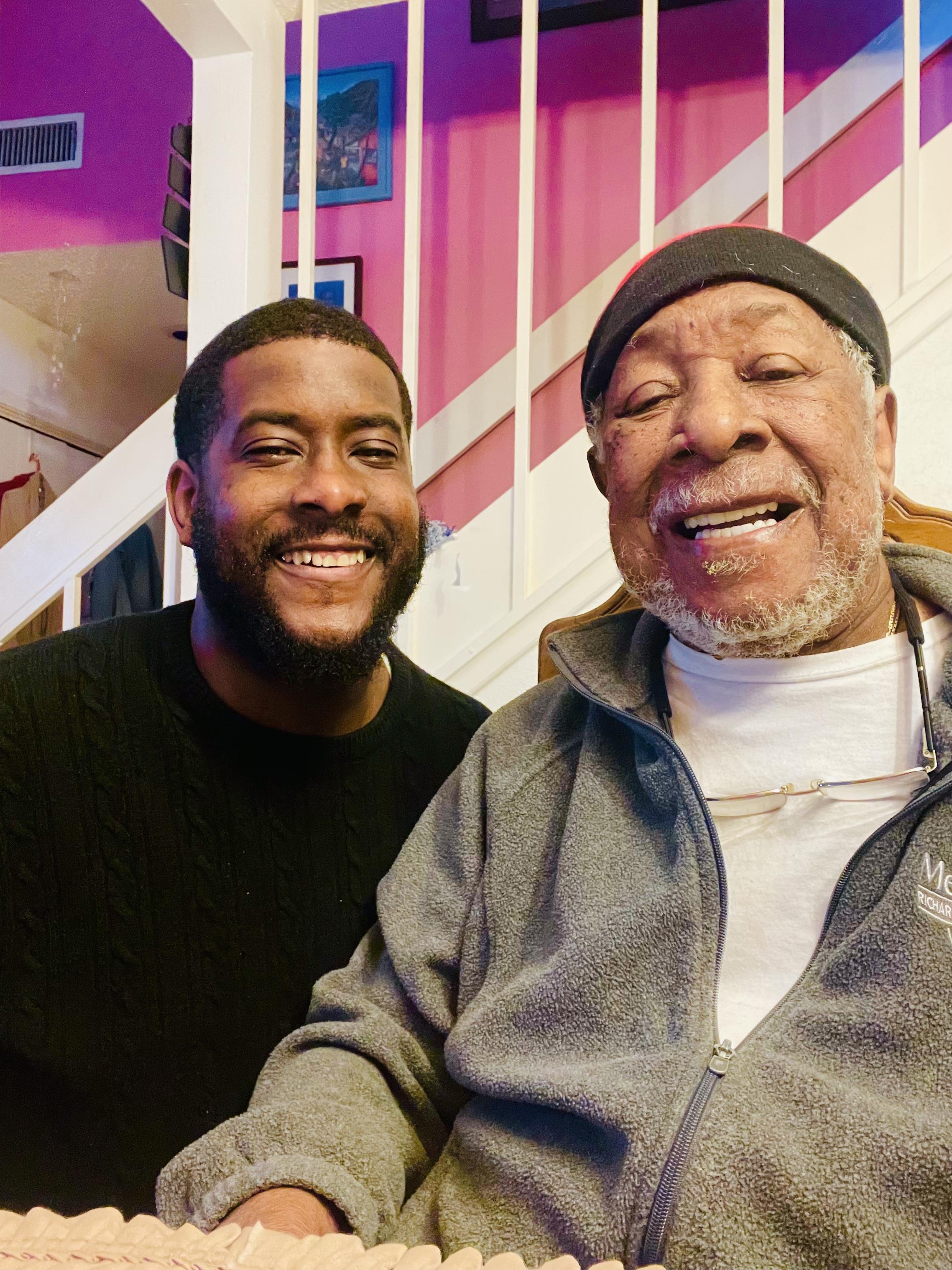 Two generations share a joyful moment, showcasing warmth and connection in their lively home.