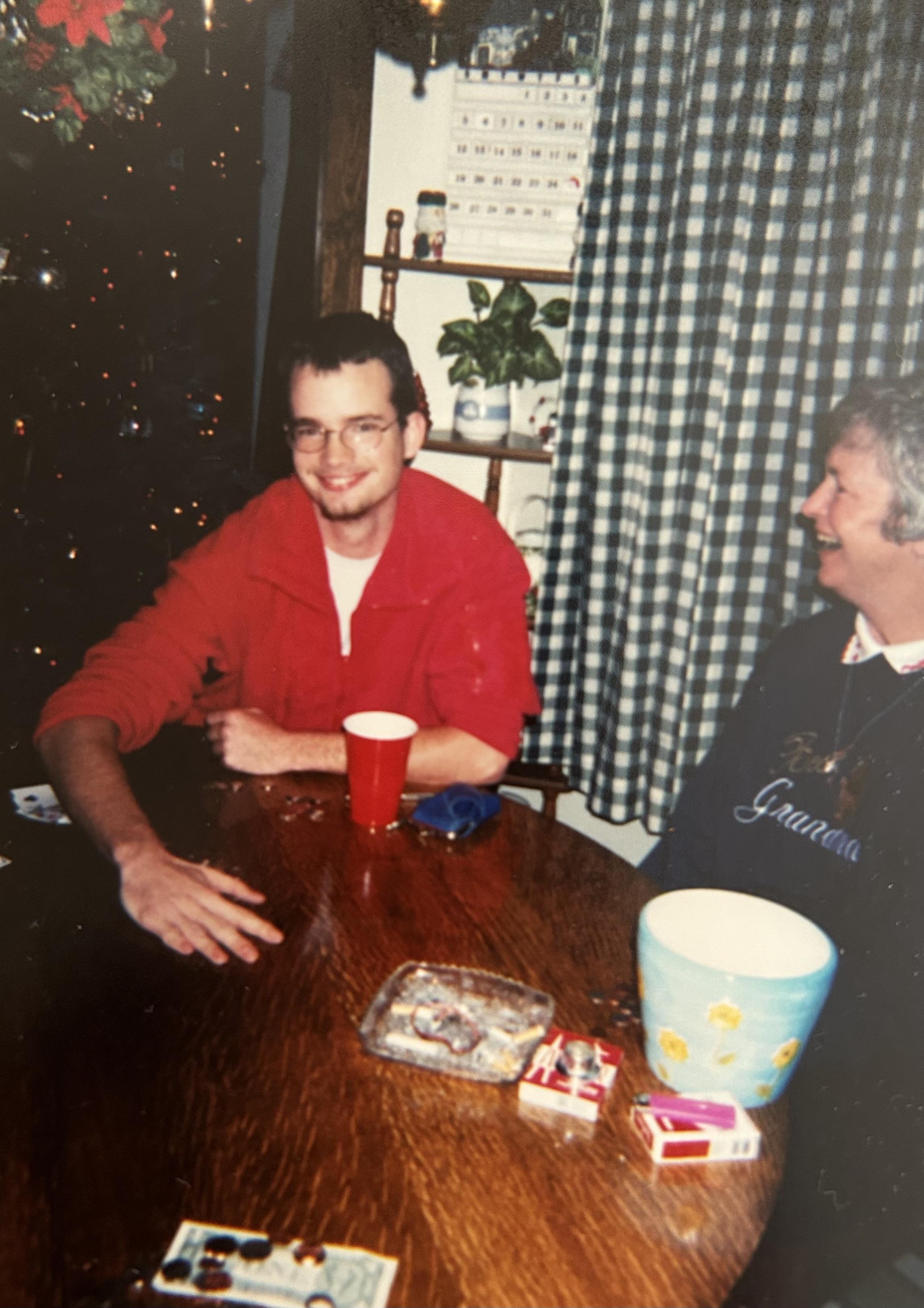 Two friends share smiles and conversations around the table filled with snacks and drinks.