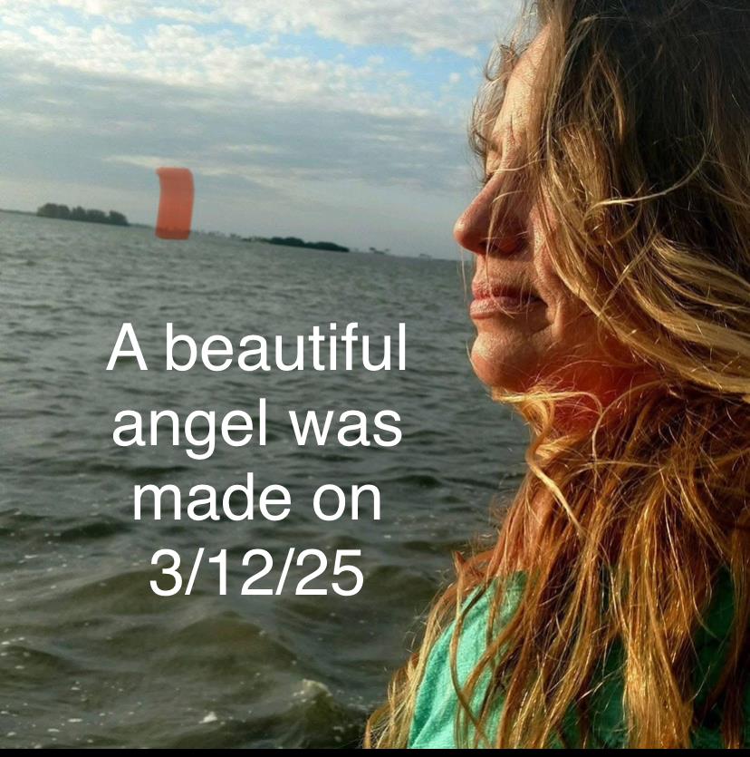 A woman gazes thoughtfully at the lake while the sun begins to set, creating a tranquil atmosphere.