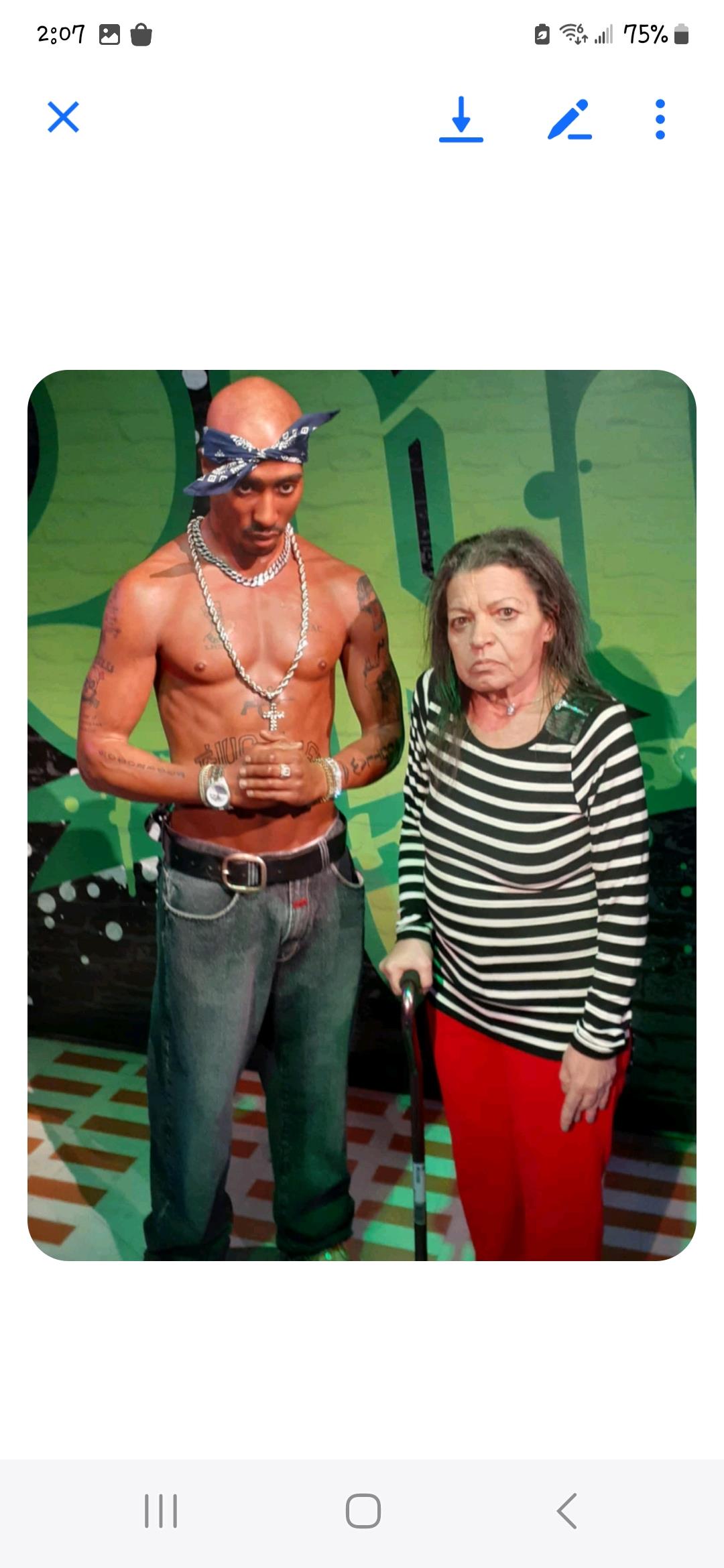 A rap icon stands beside an elderly woman with a cane, both captured in a lively urban environment.