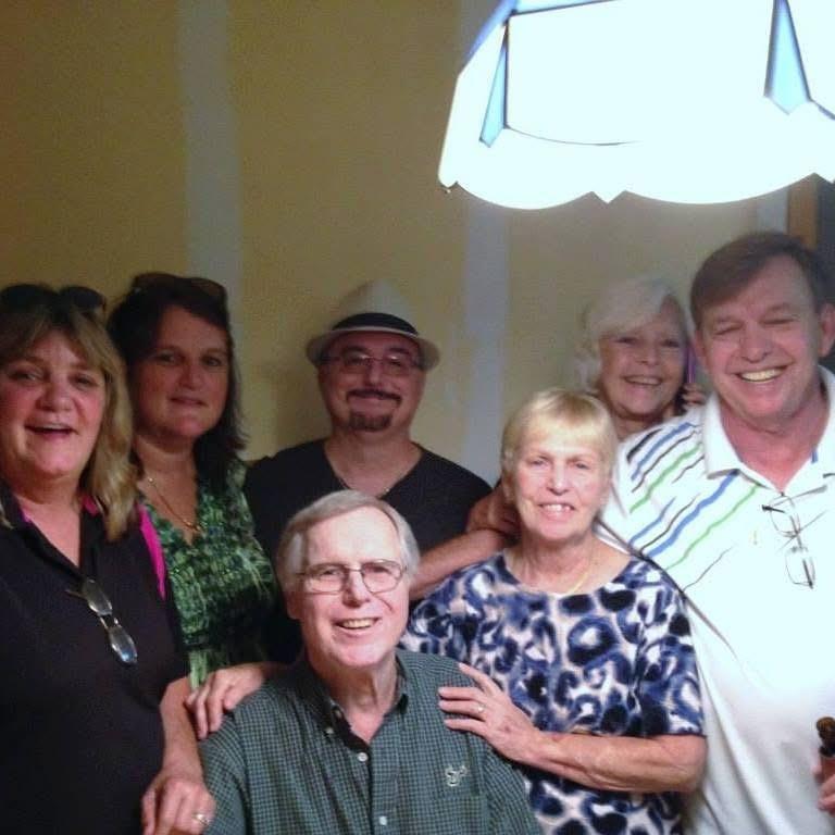 Friends gather indoors, sharing stories and enjoying each other's company.