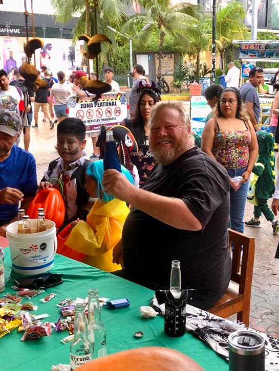 A man sitting at a table with a drink bottle