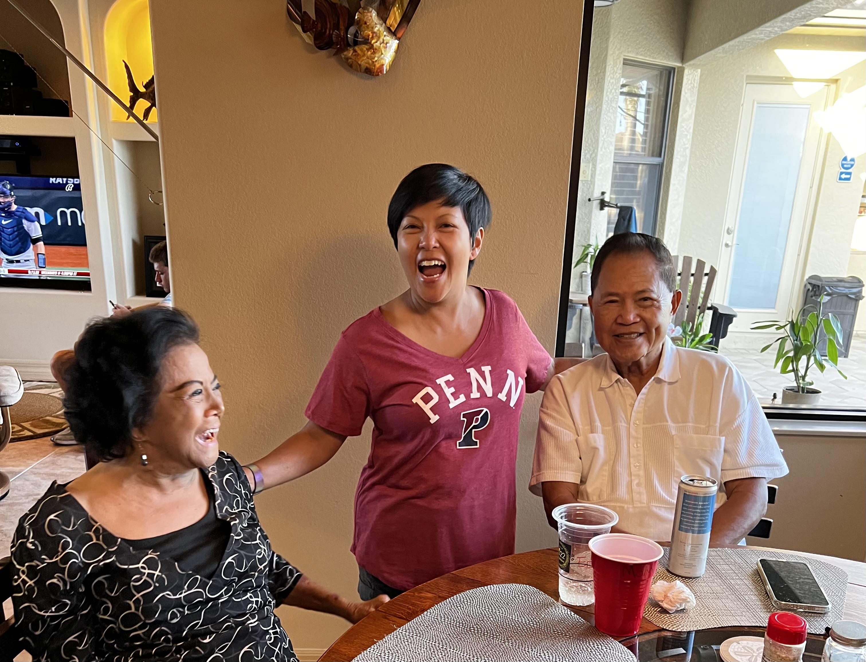 Friends enjoy a lively interaction in a welcoming living space with natural light and laughter.