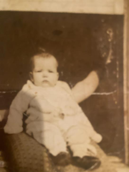 A baby sitting on a chair