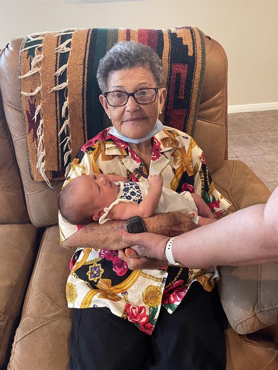 An old woman holding a baby