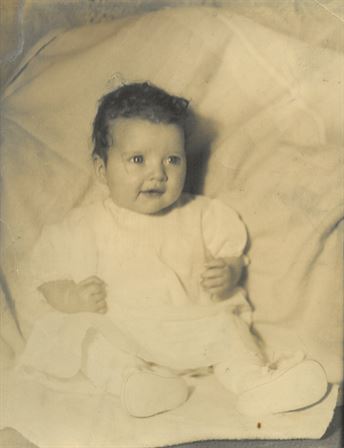 A baby in a white dress