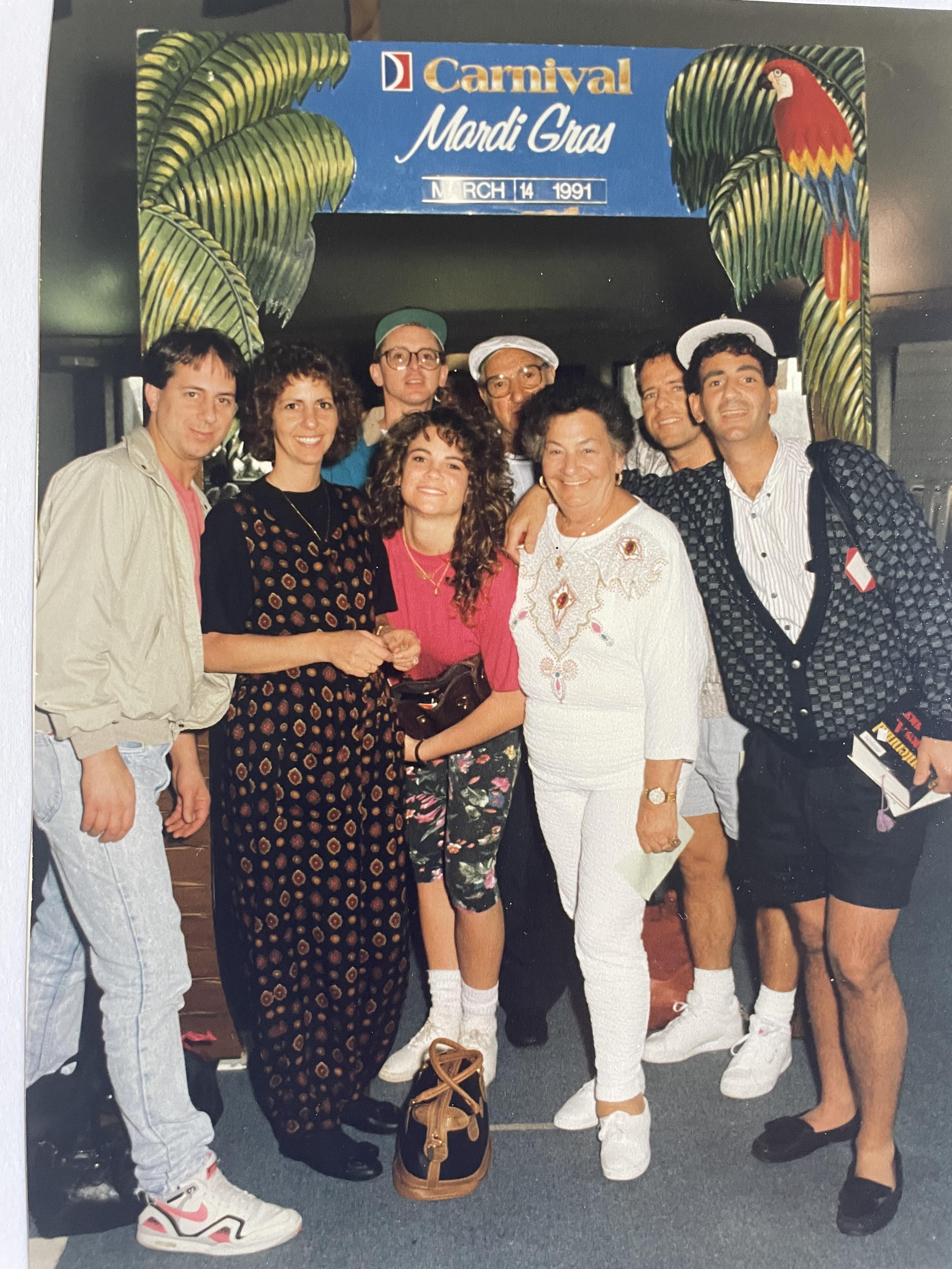 A lively group gathers for Mardi Gras festivities, sharing smiles and camaraderie.