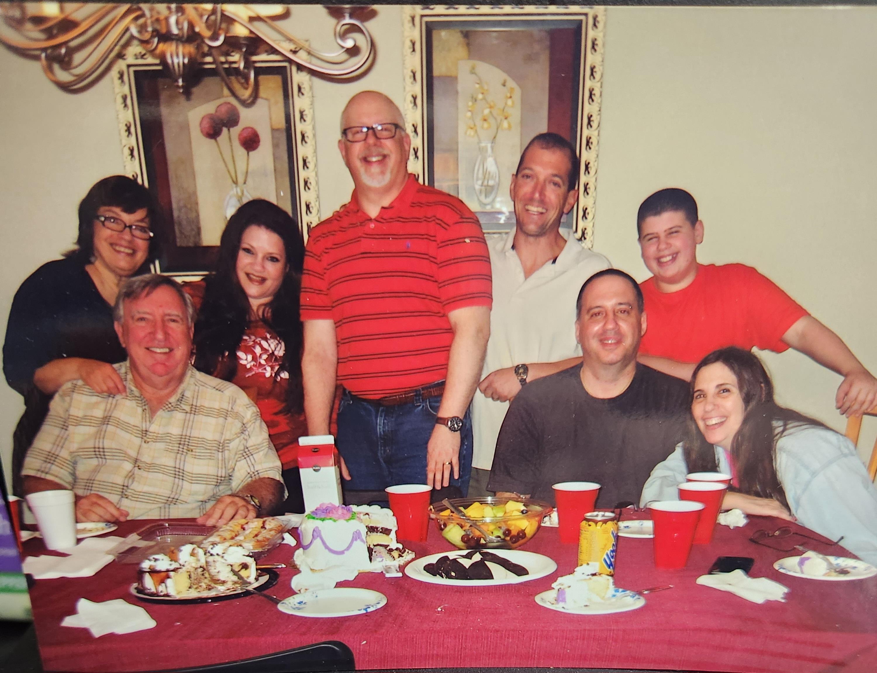 A cheerful family enjoys a lively meal together, surrounded by tasty dishes and drinks.